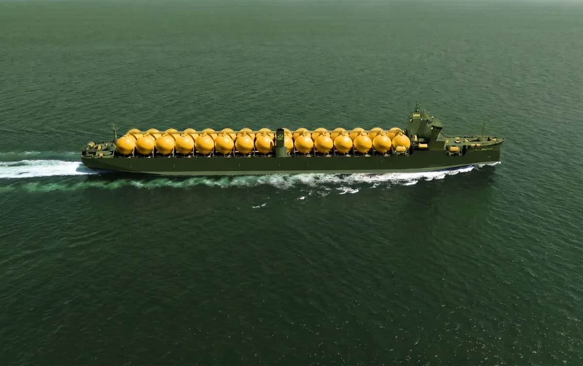 Aerial view of an LPG and ammonia gas carrier under way across a deep-green sea, its deck lined with a long row of amber spherical pressurised cargo tanks